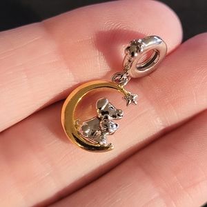 Charm silver cat and dog sitting on a golden crescent moon looking at a star